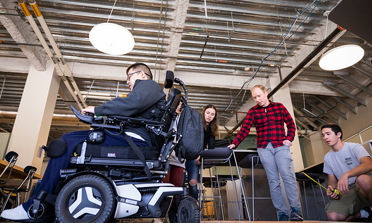 Students working on wheelchair lift